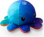 This cute TeeTurtle Reversible Sunset and Mermaid Octopus Plushie from Everything Games is the perfect gift! It features a slightly angry expression and divides into two vibrant halves, with one side in shades of blue and turquoise, and the other in a mix of purple and blue. Its large dark eyes are set on the blue side, highlighting a detailed spiral pattern on its head.