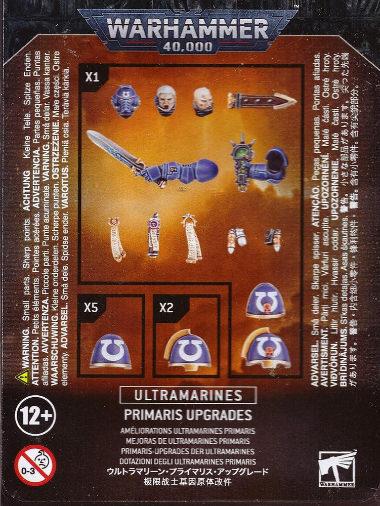 The image shows the packaging for "ULTRAMARINES: PRIMARIS UPGRADES" by Games Workshop. It includes various components for customization: a sword with a hand, a plasma pistol with a hand, power armour shoulder pads with Ultramarines insignia, a head with a laurel wreath, and a helmet. Suitable for ages 12+.