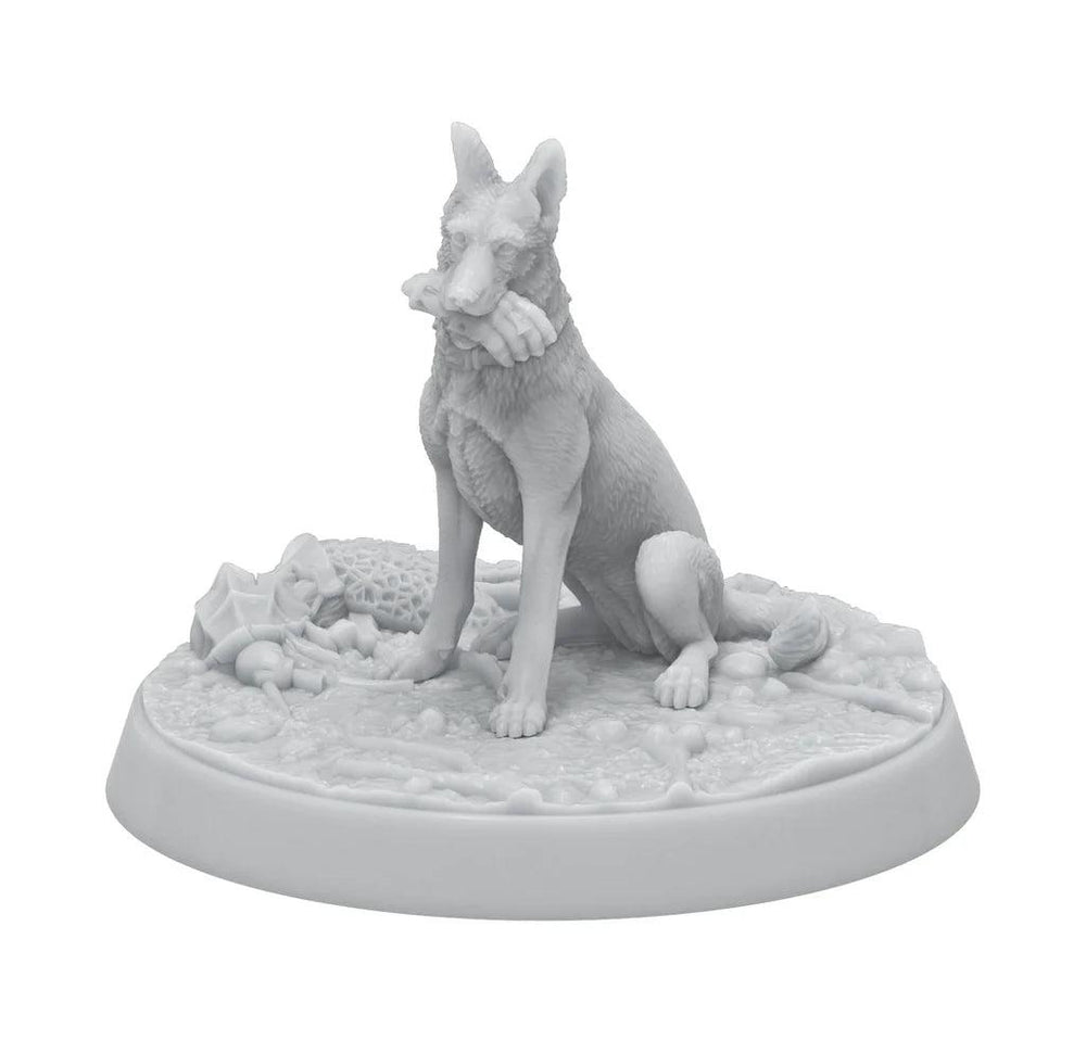 A white figurine of a seated German Shepherd on a round base, perfect for any Fallout: Miniatures - Hollywood Heroes (Amazon TV Show Tie-In) set by Modiphius. The dog holds a human hand in its mouth, and the base is textured with detailed ground features including bones, rocks, and vegetation. The entire sculpture is monochromatic and intricately designed.