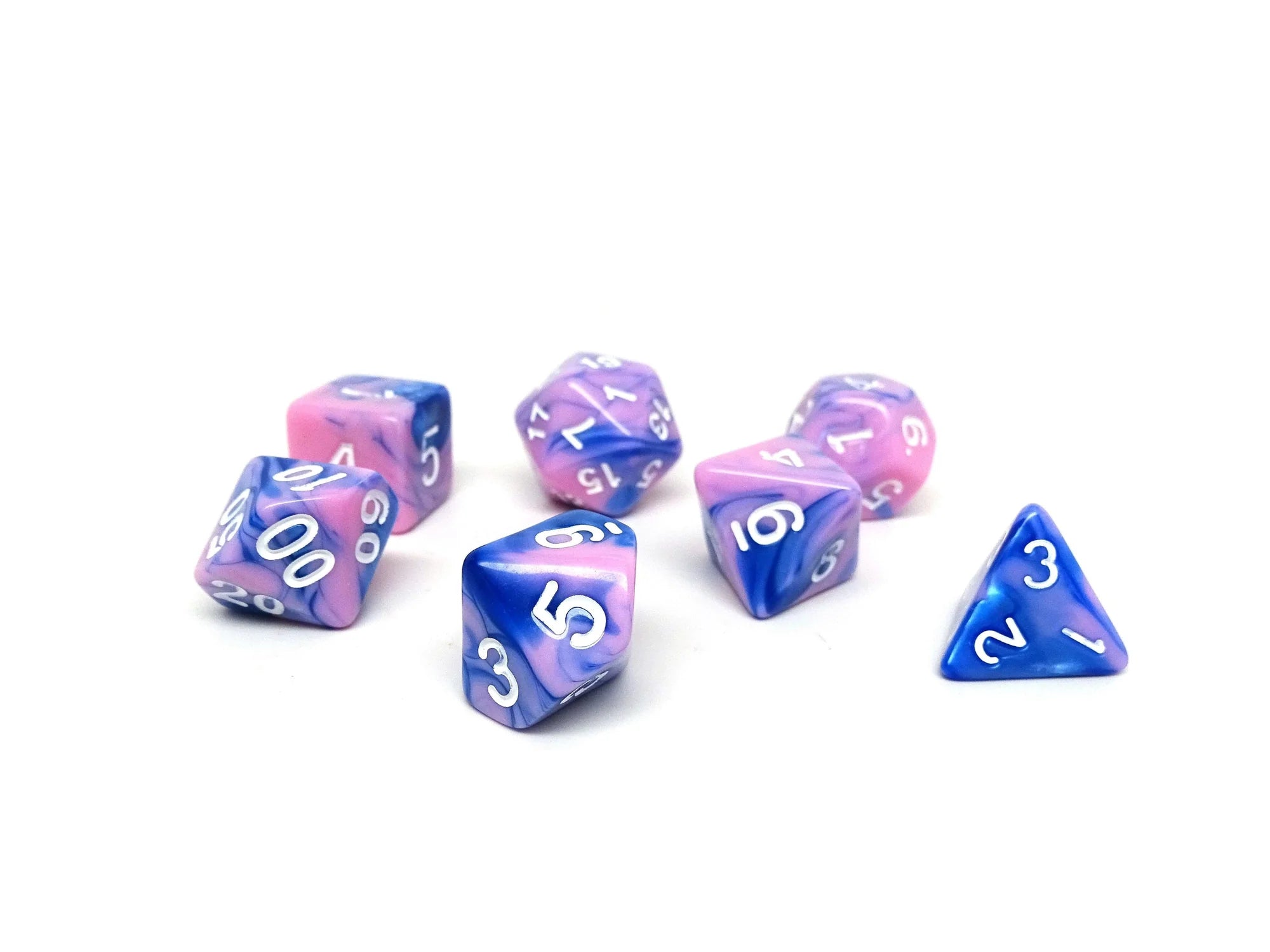 Introducing the breathtaking Pink and Blue Marble - 7 Piece Dice Collection by Easy Roller. This exquisite set features seven marble dice in different shapes and sizes, swirling with vibrant purple and pink hues. The distinctive white numbering beautifully contrasts each unique face, showcased elegantly against a plain white background.