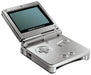 A silver Nintendo Gameboy Advance SP handheld gaming console is shown open. It has a flip-up, backlit screen, a directional pad, A and B buttons, and two small speaker holes on the right side of the lower half. The device features a sleek, metallic design with a rectangular silhouette.