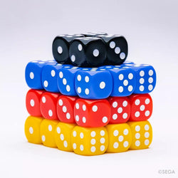 A pyramid of colorful dice sits on a white background, echoing Sonic the Hedgehog: Sonic Roll's vibrant hues. The layers are yellow, red, blue, and topped with black dice featuring white dots for numbers. The SEG logo appears in the bottom right corner. Made by Kessler Corporation.