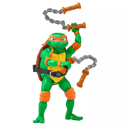 An action figure of Michelangelo from the Teenage Mutant Ninja Turtles movie stands on one leg. The green turtle wears an orange mask, elbow and knee pads, and a shell with a belt, holding nunchaku in each hand. The expressive face and dynamic pose capture the essence of the Playmates Toys Teenage Mutant Ninja Turtles: Mutant Mayhem Michelangelo Action Figure perfectly.