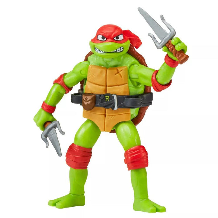 This Playmates Toys Teenage Mutant Ninja Turtles: Mutant Mayhem Raphael Action Figure features a green, humanoid turtle with an angry expression, wearing a red bandana and matching elbow and knee pads. Equipped with two sai weapons, it sports an orange shell front and black belt marked "R," plus a brown shell on its back. Packaged in Mutant Mayhem style.