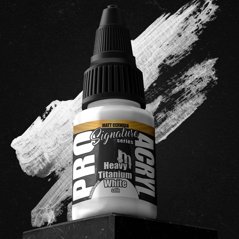 A bottle of Heavy Titanium White from Monument Hobbies rests against a textured black and white brushstroke background. The label reads 