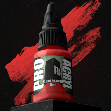 A small bottle of Monument Hobbies' Pro Acryl Fluorescent Red rests on a dark stone block. The high-density pigment stands out against the red paint stroke. Its no-clog cap and textured lid enhance the label's bold green and white text, contrasting with the black background.