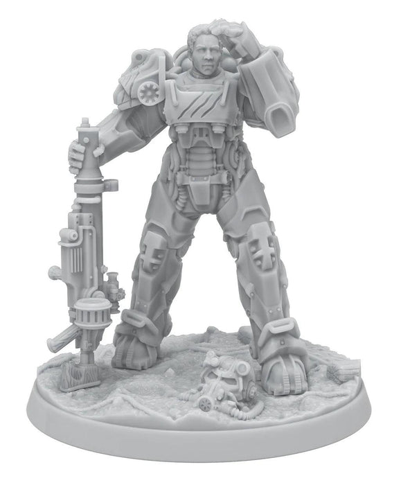 A highly detailed miniature figurine of a soldier in futuristic power armor stands on a textured, rocky base. The armor features intricate mechanical components and the soldier holds a large, advanced weapon with both hands. A damaged gas mask lies on the ground near the figure's feet, evoking scenes from Fallout: Miniatures - Hollywood Heroes (Amazon TV Show Tie-In) by Modiphius.