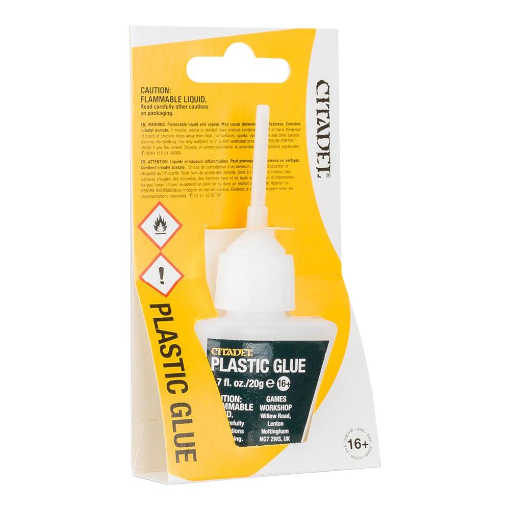 The Citadel Plastic Glue package, ideal for assembling miniatures, includes a white bottle with an applicator nozzle. The label has flammability and age restriction (16+) symbols. It features yellow and white packaging with 