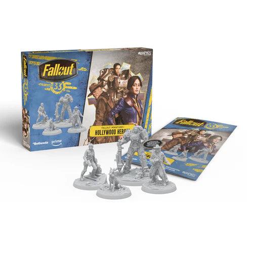 Box for "Fallout: Miniatures - Hollywood Heroes (Amazon TV Show Tie-In)" expansion by Modiphius beside five unpainted miniature models and an instruction booklet. Background features artwork from the Fallout series, including characters in post-apocalyptic gear, reminiscent of scenes from the Fallout TV series.