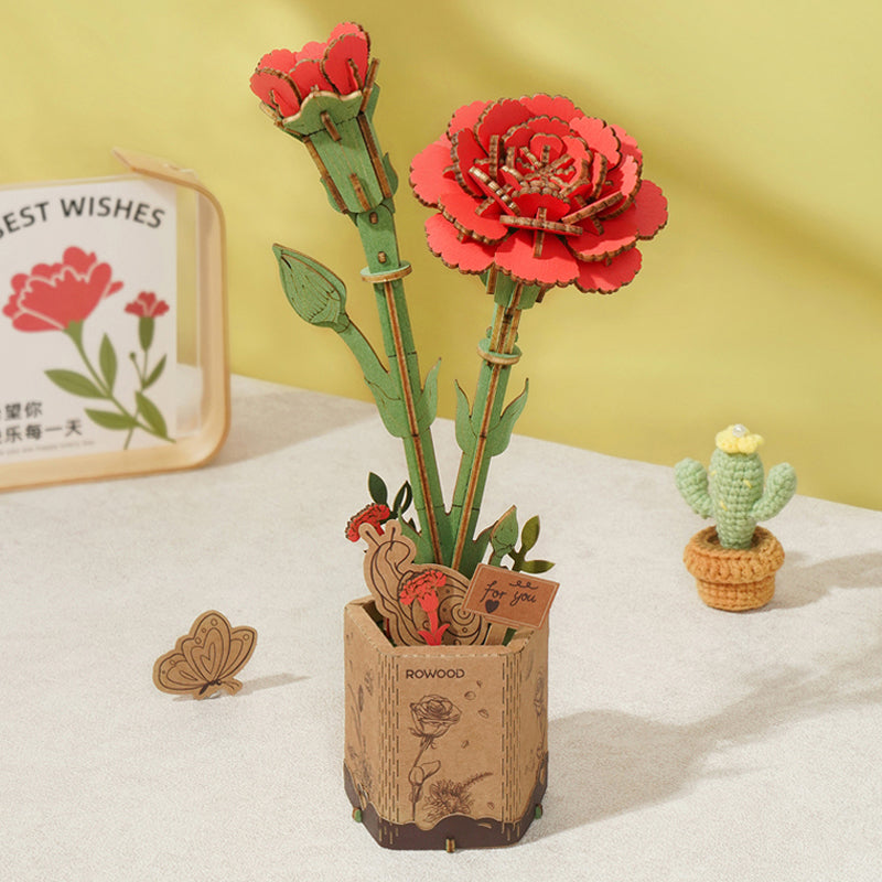 Robotime's Red Carnation is a decorative Wooden Bloom Craft with two red carnation sculptures in a wooden pot, featuring green stems, carved details including a butterfly, and a 