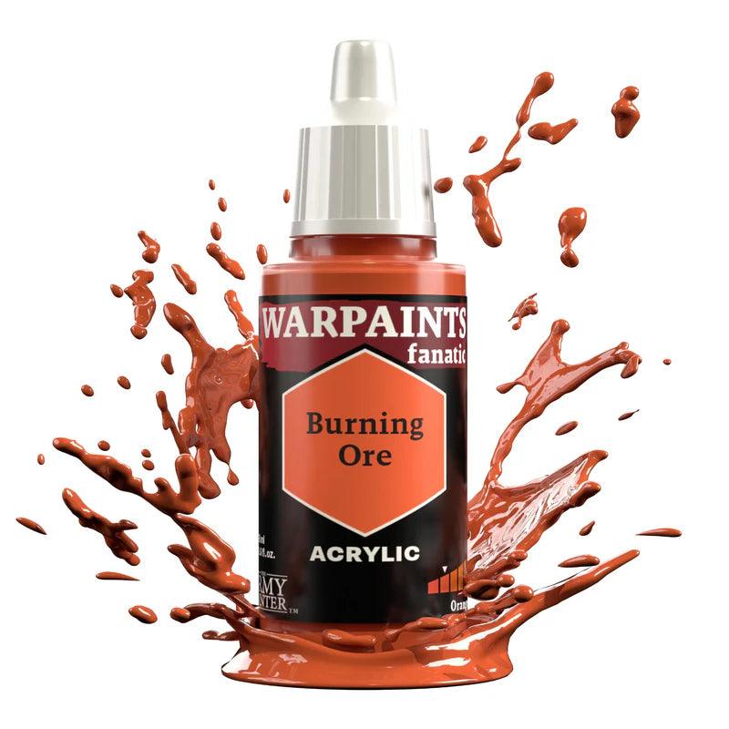 A bottle of Warpaints Fanatic: Burning Ore by Everything Games sits amid reddish-brown splatters, showcasing its vibrant hue. The hexagonal label displays the name, while a white cap tops the scene, creating a dynamic splash with this flexible color triad.