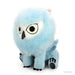 A KidRobot Dungeons & Dragons - Phunny Plush - Snowy Owlbear resembling a mythical creature with a large, round, light blue fluffy head, yellow eyes with black pupils, and a beak-like nose. It has blue wings and four blue limbs, each with black, paw-like detailing at the bottom. The toy is seated and facing forward.