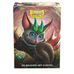 An artwork featuring a fantasy creature with large ears, vivid green eyes, and a leaf-shaped crest, sitting on a branch. Its brown fur and gentle expression create an enchanting presence as it overlooks a magical forest. The scene is crowned with "Dragon Shield" while "100 Brushed Art Sleeves" ensures protection for your TCG cards below. This product is known as Dragon Shield: Standard 100ct Brushed Art Sleeves - The Bushdrake by Arcane Tinmen.