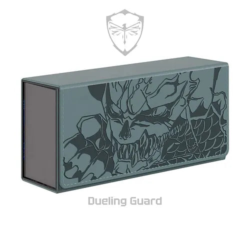 A rectangular gray KAIJU NO .08 Deck Box from Dueling Guard is adorned with detailed, menacing skull and dragon artwork. The design features intricate scales and sharp angles. The top of the card storage box showcases a shield with a symbol resembling insect wings, and the words "Dueling Guard" are written in gray below the box.