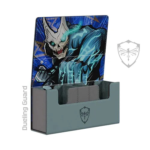 The KAIJU NO .08 Deck Box by Dueling Guard is a gray deck box with an open lid featuring an illustration of a menacing creature. The creature has a skeletal face and a glowing blue hand. Crafted from durable vegan leather, the interior is divided to hold multiple card decks. Featuring on the front and side of the box, the logo displays a shield with a stylized creature's face.