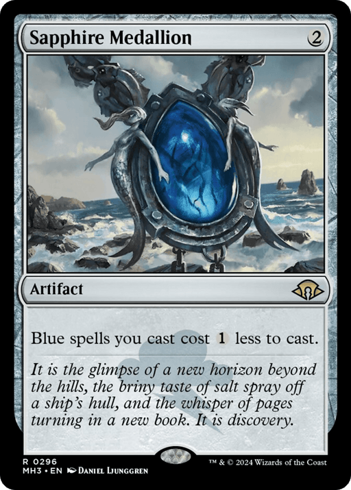 The image is of a Magic: The Gathering card named "Sapphire Medallion [Modern Horizons 3]," featured in Modern Horizons 3. It is an artifact card that costs 2 mana to cast. The art depicts a large blue gem encircled by ornate silver designs, set against a stormy ocean backdrop. The text indicates blue spells cost 1 less to cast.