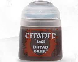The image features a bottle of Citadel Base - Dryad Bark paint with a gray flip-top lid. The label on the bottle reads "CITADEL BASE DRYAD BARK," indicating the paint color inside is Dryad Bark, a shade of brown. These high-quality acrylic paints are perfect for base coating your Citadel miniatures, beloved by hobbyists.