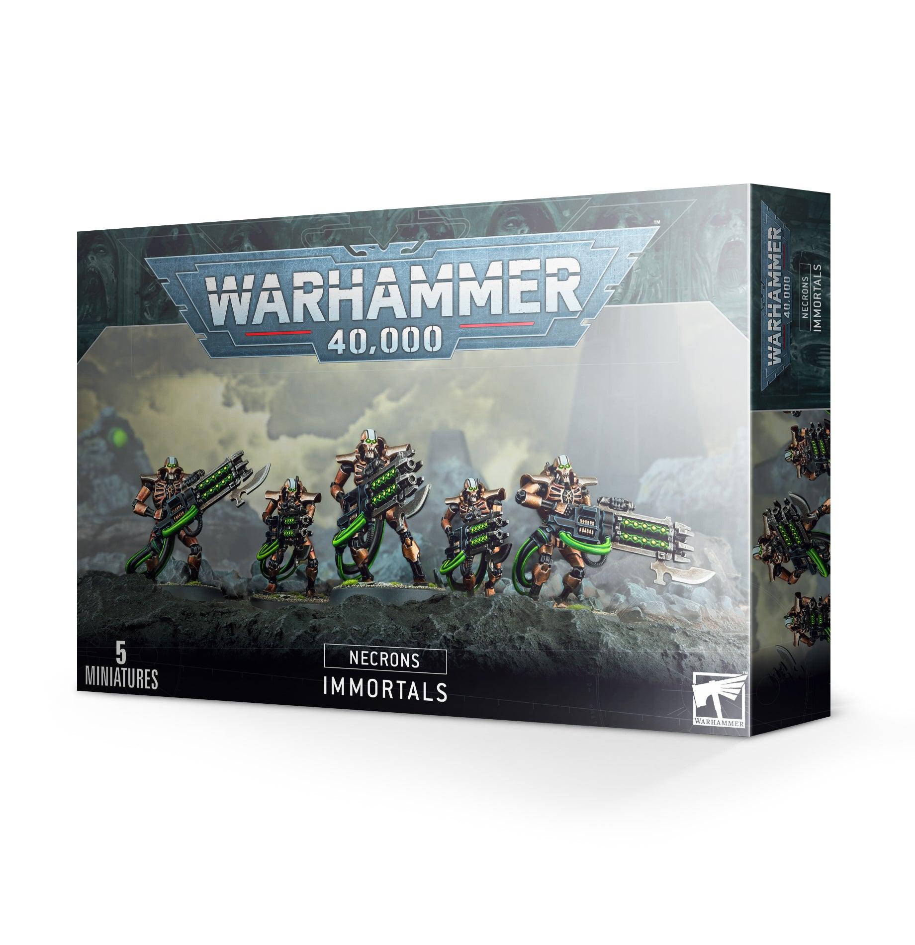 Box of Games Workshop NECRONS: IMMORTALS miniatures. The front showcases five painted Necrons armed with gauss blasters and tesla carbines, set in a battle scene. The bold Games Workshop logo crowns the box, while 