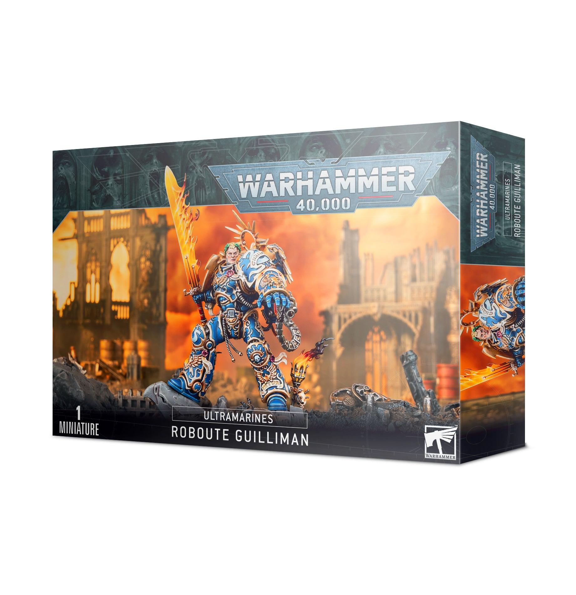 Box art for a Games Workshop miniature of ULTRAMARINES: ROBOUTE GUILLIMAN, the Ultramarines Primarch known for his strategic brilliance. The box displays an armored warrior holding a glowing sword, with a ruined gothic cityscape in the background. The upper text reads 