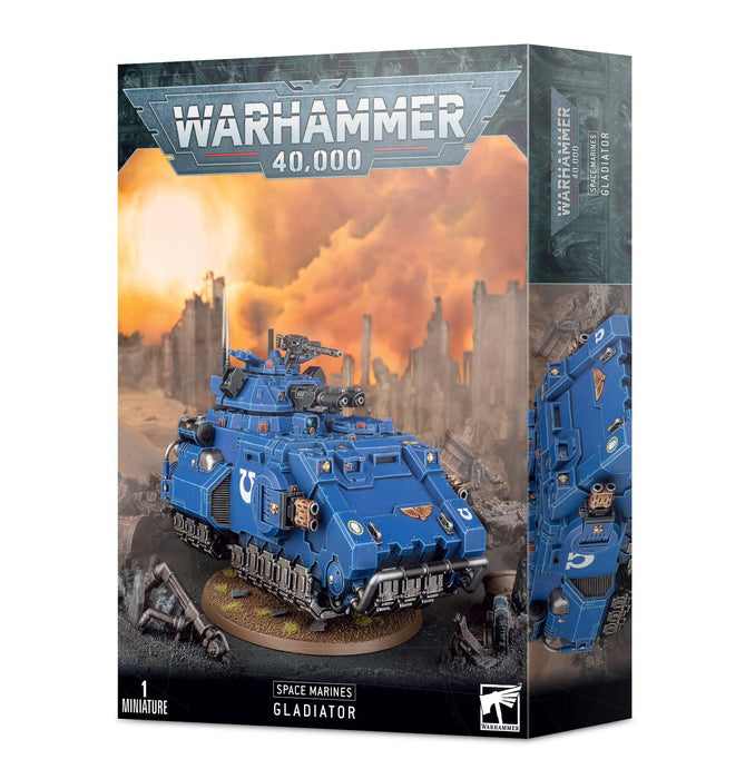 Box of Games Workshop "SPACE MARINES: GLADIATOR" model kit. The image on the box showcases a detailed, painted blue armored tank equipped with twin las-talons against a war-torn, fiery background. The text at the top reads "Warhammer 40,000," and there is a white "Space Marines Gladiator" label at the bottom.
