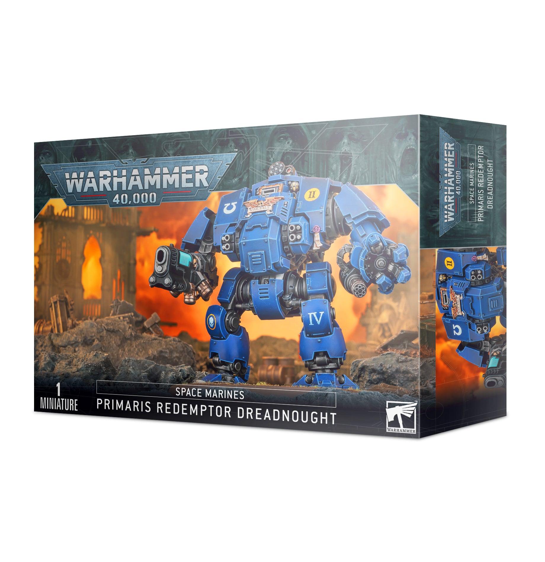 Box art of a SPACE MARINES: PRIMARIS REDEMPTOR DREADNOUGHT model kit. The front showcases a massive blue war machine equipped with multiple guns and armor, standing in a battle-damaged environment. The branding 