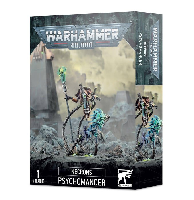 A product box for a Games Workshop miniature labeled "NECRONS PSYCHOMANCER." The cover art shows a detailed, robotic figure with a skeletal appearance, holding an abyssal lance glowing green, standing on battle-scarred terrain. There are faintly visible structures and machinery in the background.