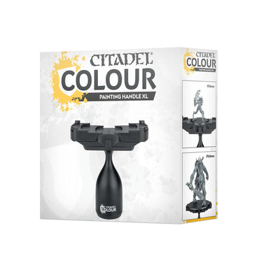 The image displays the packaging for Games Workshop's CITADEL COLOUR PAINTING HANDLE XL. It features an ergonomic base, a paint splash in the top left corner, prominently showcases the product name, and has side images showing its secure hold on miniature figures while painting.