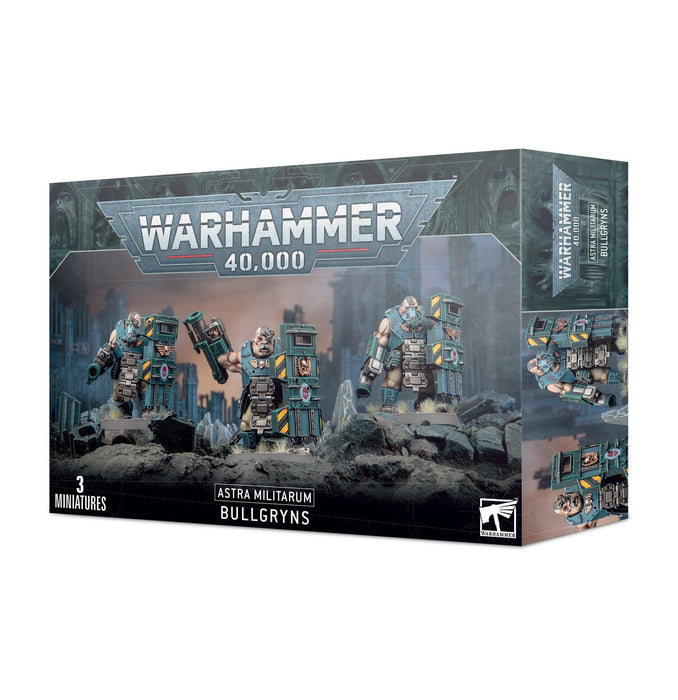 A boxed set of Warhammer 40,000 miniatures titled "ASTRA MILITARUM: BULLGRYNS" from Games Workshop. The box art features three heavily armored miniatures with large shields and assault weaponry, standing in a gritty, war-torn environment. The branding and title are prominently displayed, along with an age rating of 12+.
