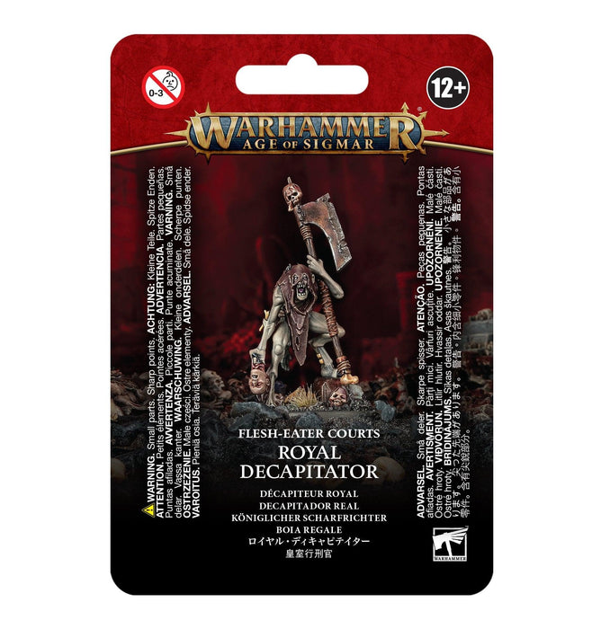 The image shows packaging for a Games Workshop model, titled "FLESH-EATER COURTS: ROYAL DECAPITATOR." The blister pack has a red and black design with the executioner miniature displayed in the center. Text includes age recommendation (12+), product safety warnings, and the logo for Warhammer Age of Sigmar.