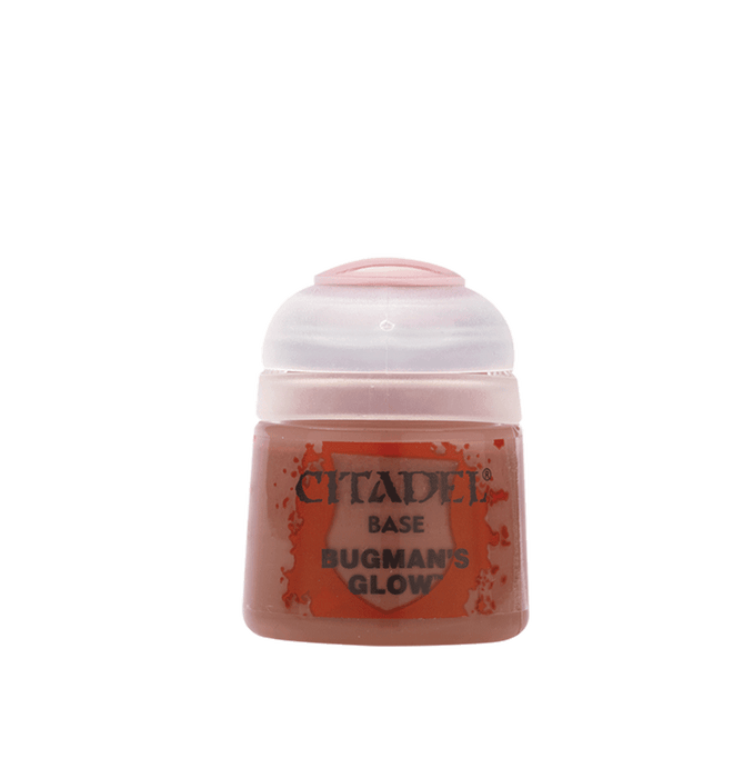 A small plastic paint pot with a white cap labeled "Citadel" is shown, perfect for painting miniatures. The pot contains a pinkish-brown acrylic paint named "Citadel Base - Bugman's Glow." The label reads "Citadel Base - Bugman's Glow" in black text, with an orange trademark symbol behind it.
