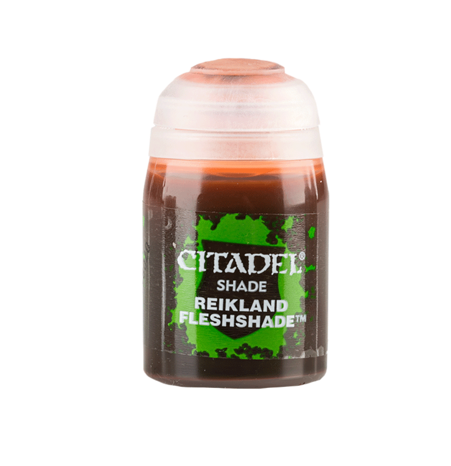 A small, cylindrical container of Citadel Shade paint labeled "Citadel Shade - Reikland Fleshshade" on the front. Ideal for miniatures, the bottle is predominantly brown, with a green and black label bearing white text. The transparent lid is slightly frosted, revealing the matte shading color inside.