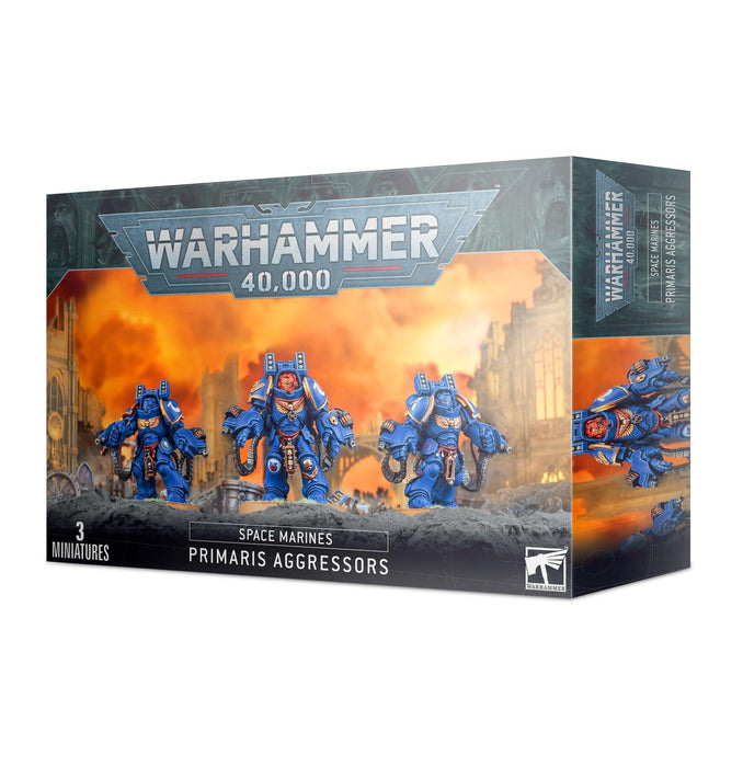 Box of Games Workshop SPACE MARINES: PRIMARIS AGGRESSORS miniatures. The packaging shows three detailed blue-armored space marines in heavy Gravis armor advancing through a fiery background. The front panel displays the Warhammer 40,000 logo at the top and "3 Miniatures" at the bottom left.