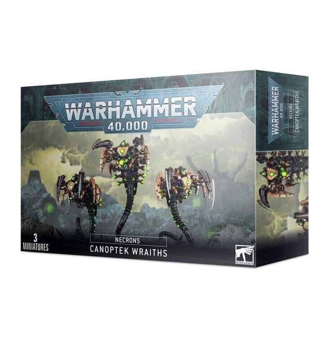 A box of NECRONS: CANOPTEK WRAITHS miniatures from Games Workshop. The box showcases three mechanical, serpentine figures with green glowing elements and a phase shifter, hinting at their dimensional destabilization matrix. The front displays the Warhammer 40,000 logo and labels indicating "3 miniatures" and "Canoptek Wraiths.