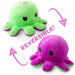 Two TeeTurtle Reversible Red and Fire Eyes Octopus Plushies are shown. One side is green with an angry expression, while the other side is purple with a happy expression. Arrows and the text "REVERSIBLE!" indicate their ability to flip between moods. This TikTok-famous cute plush toy adds a fun twist to expressing how you feel!