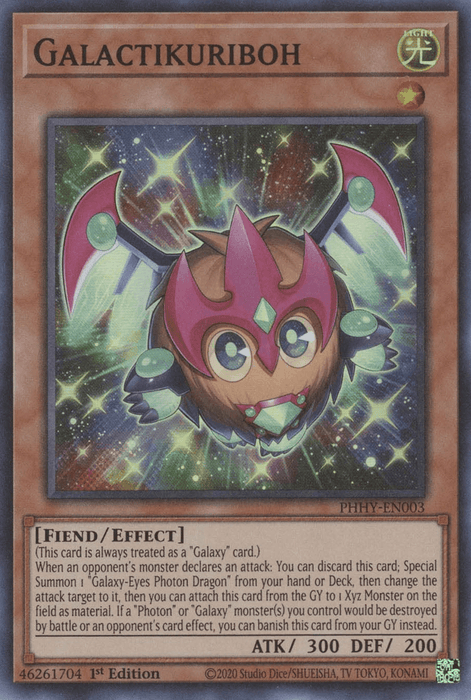 A Yu-Gi-Oh! trading card titled Galactikuriboh [PHHY-EN003] Super Rare. This Effect Monster has a light attribute and is of the Fiend type, with 300 attack and 200 defense points. The artwork depicts a small, cute, round creature with a glowing green body, large eyes, and two scissor-like appendages.