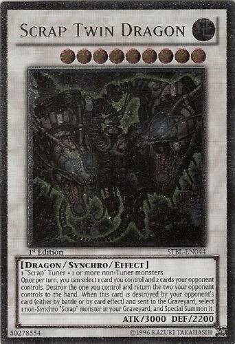 A Yu-Gi-Oh! product titled "Scrap Twin Dragon [STBL-EN044] Ultimate Rare" is an Ultimate Rare Synchro/Effect Monster. It has grey edges and depicts a mechanical dragon with green and rust-colored details. The stats are ATK/3000 and DEF/2200. This 1st Edition card features detailed effect text describing its abilities and required Scrap Tuner materials.