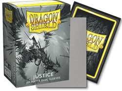 The image shows a box of Dragon Shield: Standard 100ct Art Sleeves - Justice (Dual Matte) by Arcane Tinmen, designed for TCG cards, containing 100 card sleeves. The box features artwork of a warrior battling a dragon in a dark and stormy scene. An open sleeve stands next to the box, showcasing its opaque black back and silver-grey interior.