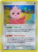 A rare Pokémon card featuring Igglybuff, a pink, round Pokémon with a swirl on its forehead and large, blue eyes. The colorless card has 50 HP and two abilities: Hover Lift and Baby Evolution. The background shows a tropical setting with palm trees. This Pokémon Igglybuff (21/100) (Stamped) [EX: Crystal Guardians] card is number 21/100.