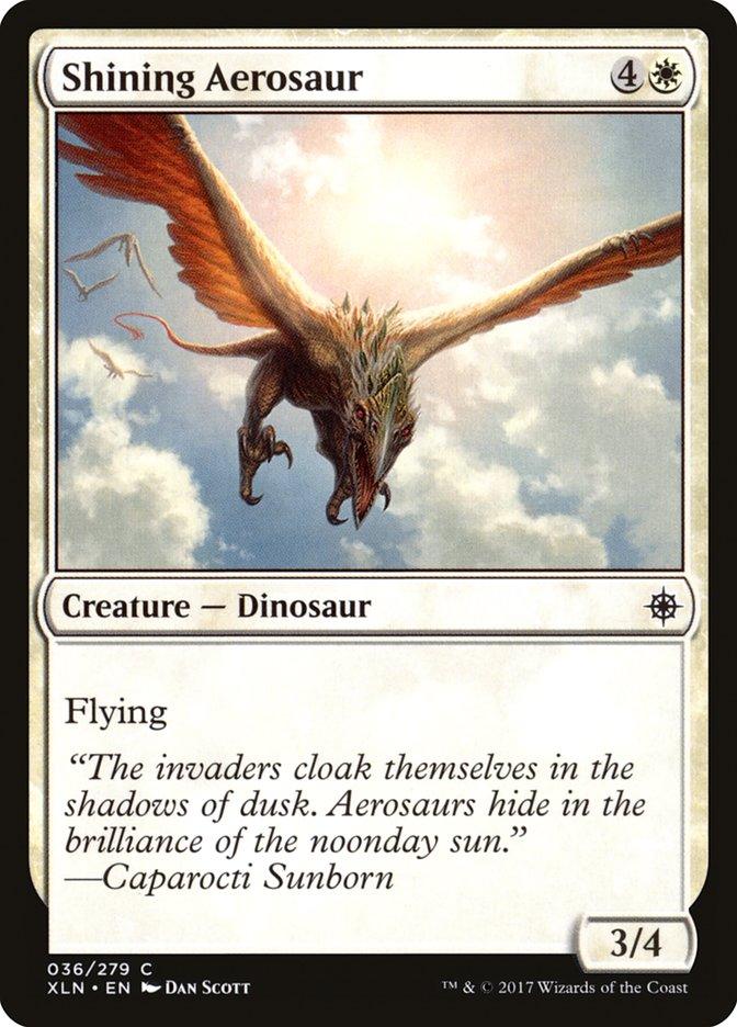 Magic: The Gathering card titled **Shining Aerosaur [Ixalan]**. This Ixalan creature is a flying dinosaur with outstretched wings against a bright sky. It has a mana cost of 4 colorless and 1 white mana, with power/toughness 3/4. Text reads: 