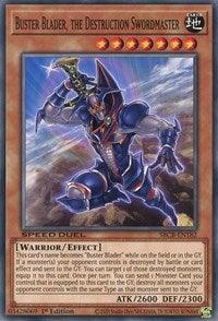 A "Yu-Gi-Oh!" card titled “Buster Blader, the Destruction Swordmaster [SBCB-EN182] Common.” This Effect Monster depicts a warrior in dark armor wielding a large sword. The card has 7 stars, indicating its level, and features an ATK value of 2600 and a DEF value of 2300. It's playable in Speed Duel and contains descriptive card text detailing its effect.