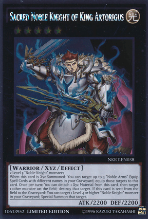 A Yu-Gi-Oh! trading card titled "Sacred Noble Knight of King Artorigus [NKRT-EN038] Platinum Rare" and belonging to the Platinum Rare series. The card features an armored Noble Knight warrior with a blue cape, holding a glowing sword. He stands against a dark background with mystical energy swirling around him, highlighting its [Warrior/Xyz/Effect] attributes.