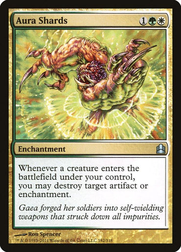 Aura Shards [Commander 2011] from Magic: The Gathering features artwork by Ron Spencer, depicting a vibrant creature emerging through a radiant aura. This enchantment card requires one green and one white mana, enabling players to target and destroy opposing artifacts or enchantments.