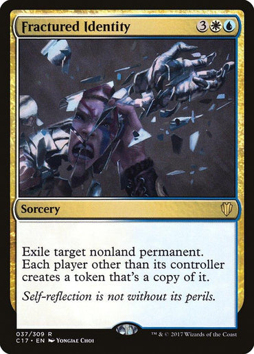 The Magic: The Gathering card "Fractured Identity" from Commander 2017 features an illustration of a person splitting into fragmented mirror shards, their distressed face reflected in multiple pieces. This rare sorcery, costing 3 white/blue mana, exiles a nonland permanent and creates copies for opponents.