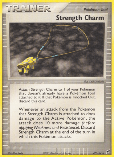 A Pokémon trading card named "Strength Charm" (92/107) from the EX: Deoxys series showcases a yellow, jagged crystal pendant on a black string against a grey background. The card describes its battle effect, adding 10 more damage when a Pokémon equipped with this tool attacks. The illustration credit and card ID are located at the bottom.