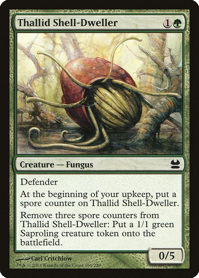 Magic: The Gathering Thallid Shell-Dweller [Modern Masters] features a green border and illustrates a fungus-covered creature in a forest. The card describes it as a 0/5 creature with Defender that can generate 1/1 Saproling tokens by removing spore counters. Art by Carl Critchlow.