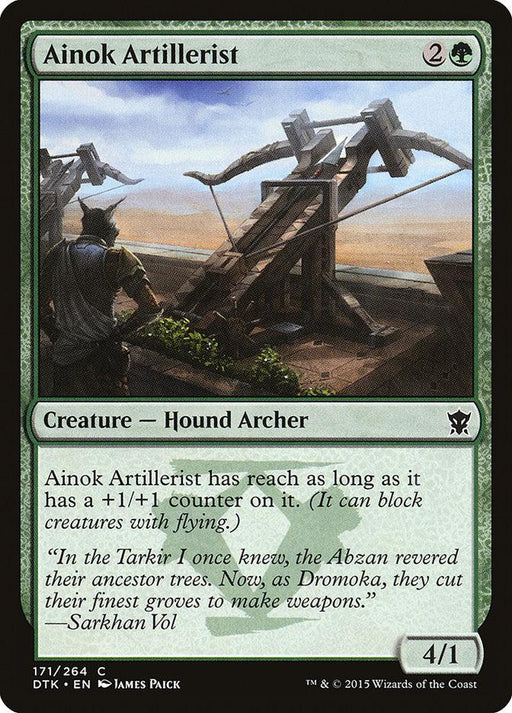 Magic: The Gathering product named "Ainok Artillerist [Dragons of Tarkir]" from the Magic: The Gathering brand. It depicts a Creature Dog Archer with a green background, showcasing a wolf-like creature operating a large wooden crossbow on a battlement. The card text reads, "Ainok Artillerist has reach as long as it has a +1/+1 counter on it.
