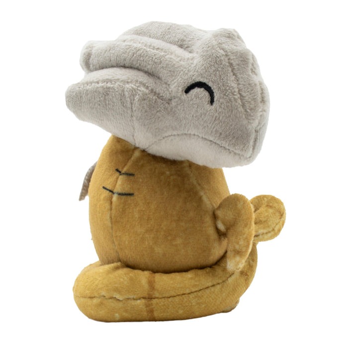 A stuffed toy resembling a simplified version of an animal, possibly a coiled snake, with a large, gray head that has a smiling expression and small, closed eyes. The body is yellowish-brown with subtle stitched lines and curves. The toy doubles as one of the cutest plush gamer pouches with a soft, plush texture. Introducing the Ultra PRO: Plush Gamer Pouche - Dungeons & Dragons (Sliver) by Ultra PRO.