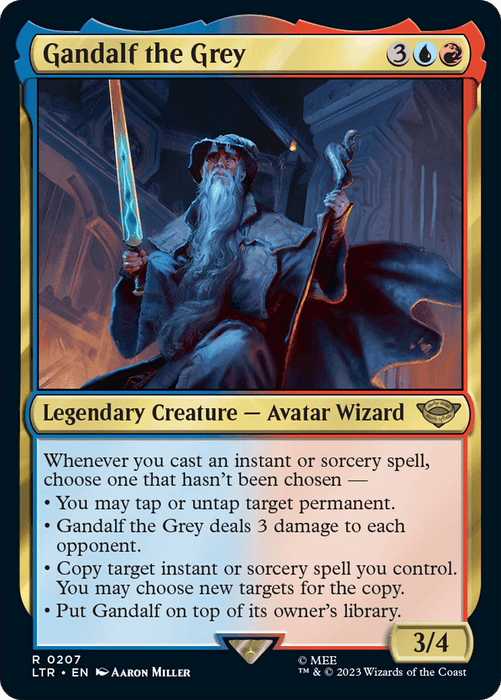 Image of a Magic: The Gathering card titled "Gandalf the Grey [The Lord of the Rings: Tales of Middle-Earth]." The card depicts an illustration of an elderly wizard holding a glowing staff and a sword, standing against a fiery background. Inspired by *The Lord of the Rings*, it is multicolored (blue and red) with a mana cost of 3 colorless, 1 blue, and 1 red. It is a Magic: The Gathering product.