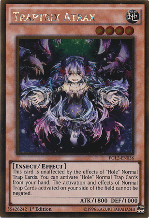Image of the Yu-Gi-Oh! card "Traptrix Atrax [PGL2-EN036] Gold Rare" from the Return of the Bling set. The card features an anime-style insectoid girl with purple hair and a dark, intricate outfit. She has a sinister expression and outstretched arms. The card's text describes her effect on Trap Cards and includes her stats: ATK 1800, DEF
