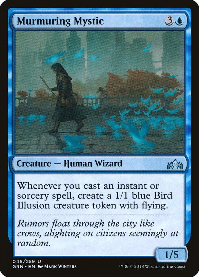 The Magic: The Gathering card "Murmuring Mystic [Guilds of Ravnica]" depicts a cloaked Human Wizard amidst a misty city, flanked by glowing blue bird illusions. It features a cost of 3U and is characterized as a Creature – Human Wizard with power/toughness rated at 1/5.